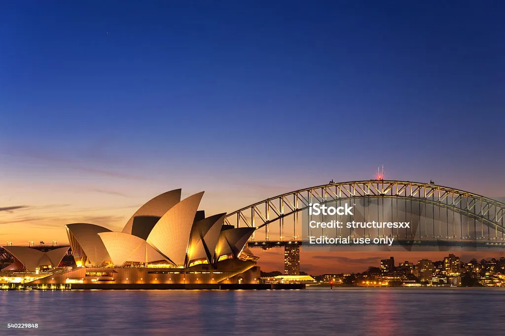 Beautiful Opera house view at twilight time with vivid sky and illumination on the bridge.